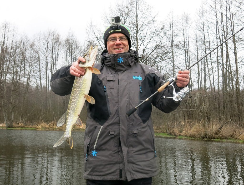 Валерий Сикиржицкий держит щуку и спиннинговую снасть