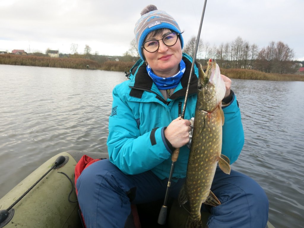 Рыбачка со щукой в лодке