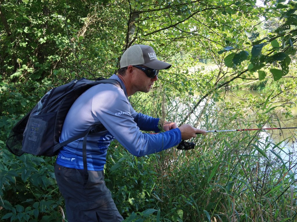 Спиннингист прячется за ветками